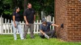 Mount Valley Foundation Services inspector and two homeowners inspecting a brick house