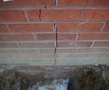 vertical crack in brick on side of house