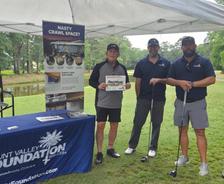 Mount Valley Foundation Services employees stand at a company booth at the 2026 Children's Miracle Network Charity Golf Tournament