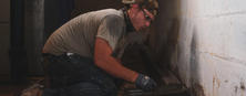 Crew installing pavement on BasementGutter in Basement
