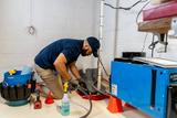 service tech checking a sump pump