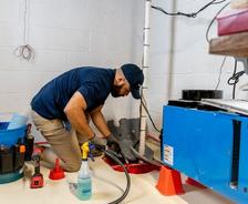 service tech checking a sump pump