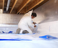 installing crawl space insulation and vapor barrier