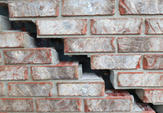 stairstep cracked brick before image