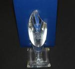 Crystal trophy with "2015 BBB Torch Awards for Ethics" engraved, displayed against a blue background.