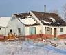 Wide shot of settling home with snow all over.
