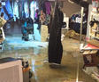 A finished basement flooding with household items damaged.