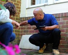 THBS CFI with homeowner inspecting brick foundation