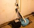 Sump pump with backup battery inside basement.