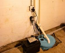 Sump pump with backup battery inside basement.