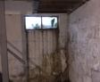 Water damage on basement window and wall