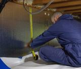 THBS is measuring crawlspace wall for a vapor barrier.