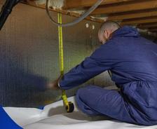 THBS is measuring crawlspace wall for a vapor barrier.