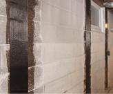 Carbon Fiber strips on cinderblock basement wall.