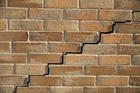 Close up of stair step cracking on brick wall