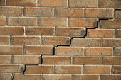 Close up of stair step cracking on brick wall