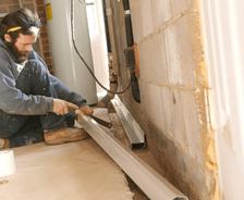THBS crew installing interior drainage in basement