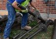 Crew picking up helical piers outside of home