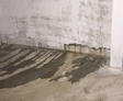 Water intrusion on basement wall and floor.