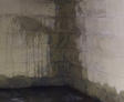 Wet cinderblock basement wall and floor.