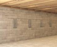 The bowing wall is being corrected with wall anchors.