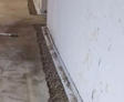 Wide shot of the basement drainage system during the installation process.