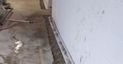 Wide shot of the basement drainage system during the installation process.