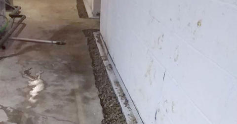 Wide shot of the basement drainage system during the installation process.