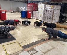 THBS crew is doing the Push-Up Challenge in the warehouse.