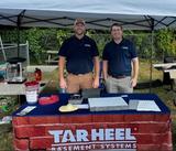 Tar Heel Basement Systems employees in a booth at an Edgebrook Pool swim meet