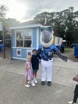 children standing with the Wilmington Sharks baseball team's mascot