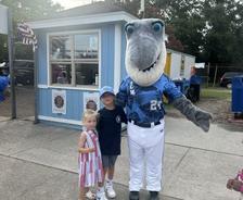 children standing with the Wilmington Sharks baseball team's mascot