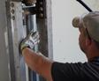 crew member installing push piers for foundation repair