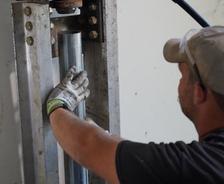 crew member installing push piers for foundation repair