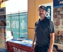 Tar Heel Basement Systems employee at a company booth during a Durham Bulls game
