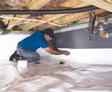 FRS crew member installing crawl space insulation