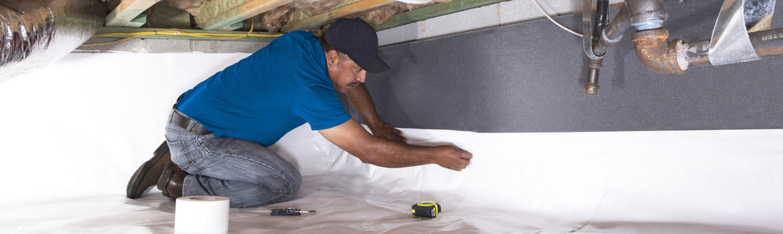 FRS crew member installing crawl space insulation