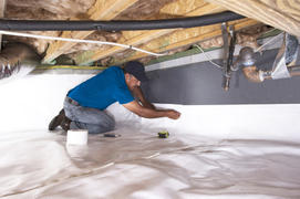 FRS crew member installing crawl space insulation