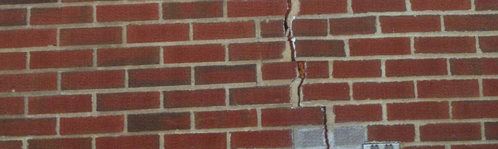 Vertical crack in brick home exterior