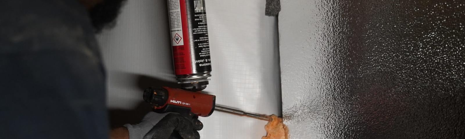 Crew installing thermal insulation with foam