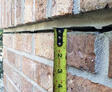Exterior crack in brick home.