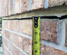 Exterior crack in brick home.