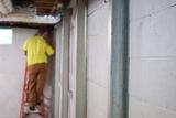 crew member installing basement wall braces