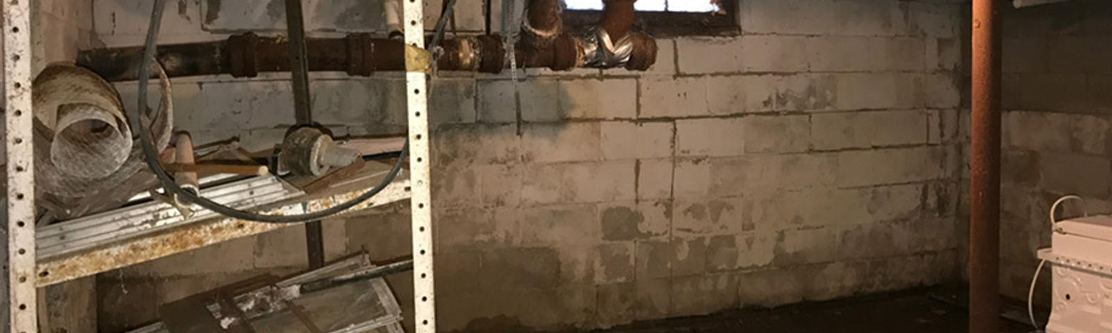 Wet basement before FRS waterproofing services
