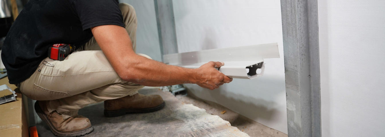 FRS Crew member installing interior drainage system