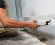FRS Crew member installing interior drainage system