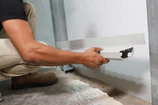 FRS Crew member installing interior drainage system