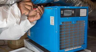 FRS crew member maintaining dehumidifier