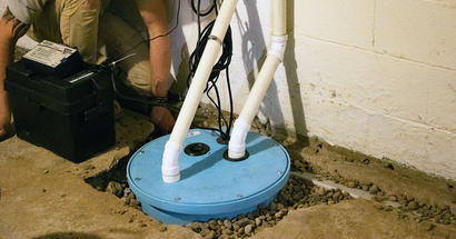 FRS crew member installing sump pump.