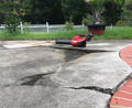 Cacked and uneven concrete pool deck.